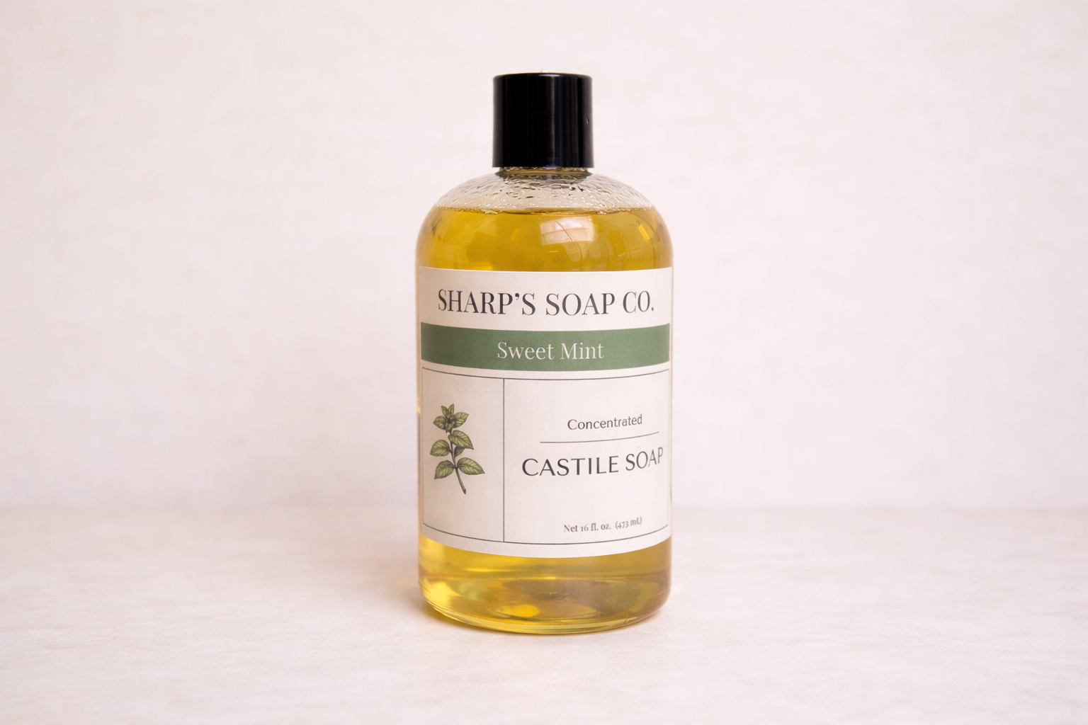 Bottle of Sharp's Soap Co. Sweet Mint Castile Soap on a white background