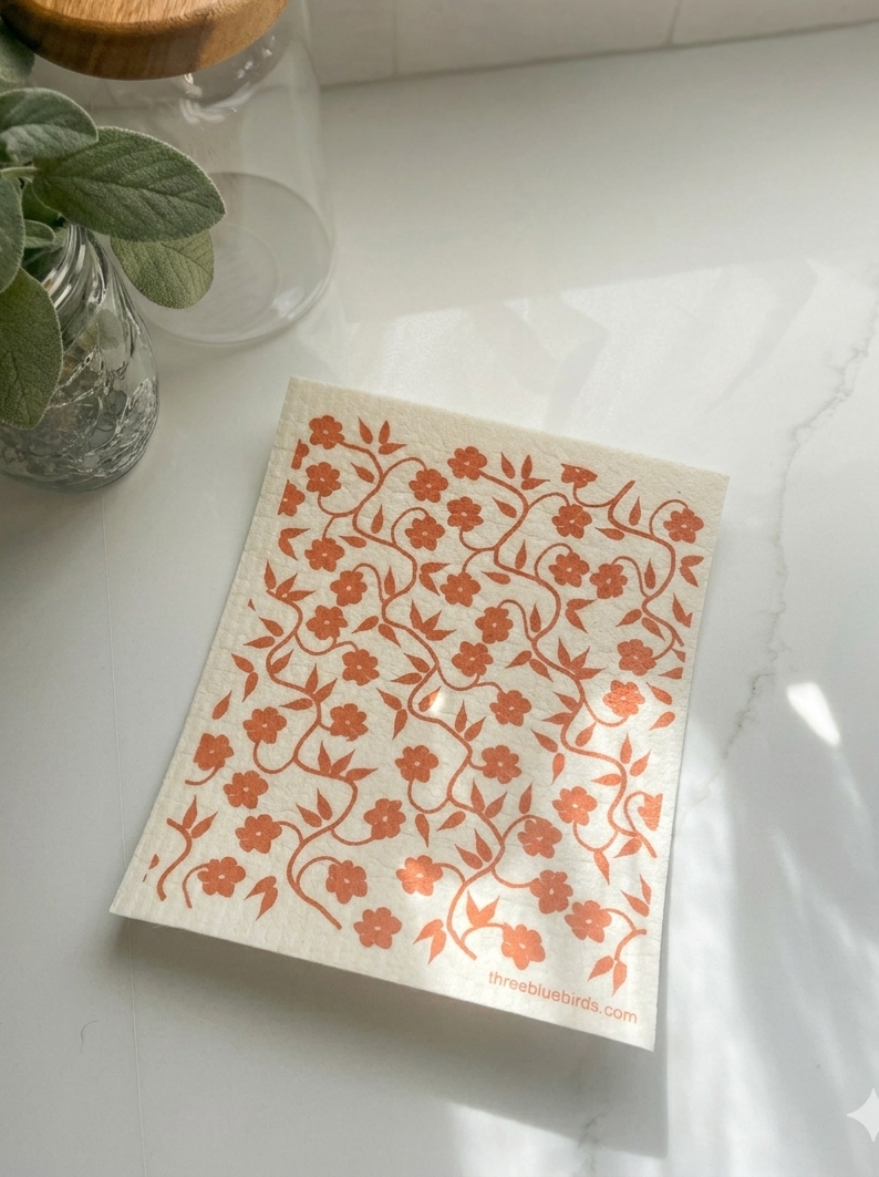 Sheet of floral stickers on a white surface with a plant in the background